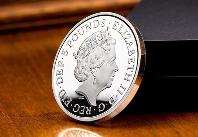 UK 2018 Four Generations Of Royalty Silver Proof Five Pound Coin Obverse leaning against display box