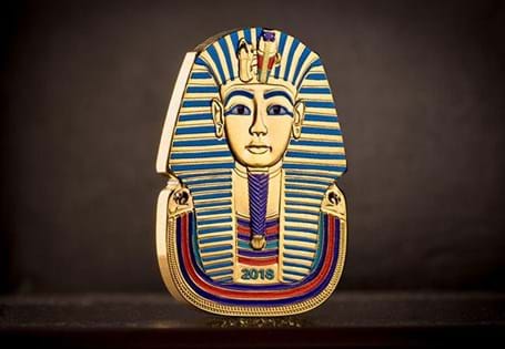 This unusual coin has been struck in the shape of Ancient Egyptian Pharoah Tutankhamun's death mask, and then expertly plated in 24ct goldwith the addition of colour detail. 