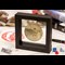 The Royal British Legion Armistice Commemorative on a desk with books in the background