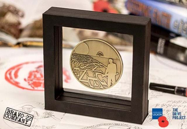 The Royal British Legion Armistice Commemorative on a desk with books in the background