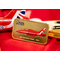 Front of the Red Arrows Gold-Plated Ingot showing an illustration of the 2015 BAE Systems Hawk, displayed in front of a Red Arrows plane model