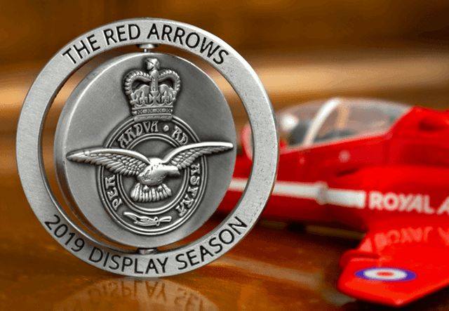 Red Arrows spinning medal brown and red background