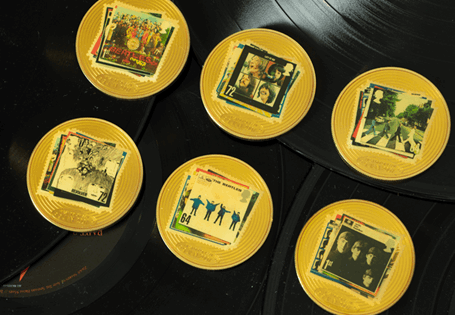 A set of 6 CuNi 24ct gold-plated Beatles Commemoratives, featuring the Royal Mail Beatles postage stamps, and engraved with the stamps's first day of issue (9th Jan 07). 