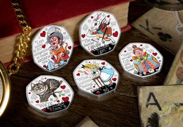 Alice's Adventures in Wonderland Silver 50p Set on wooden surface with a red book, cards and a gold watch