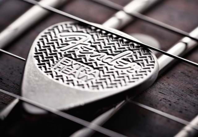 Fender-Sterling-Silver-Playable-Guitar-Pick-Product-Images-Lifestyle-Between-Strings.jpg