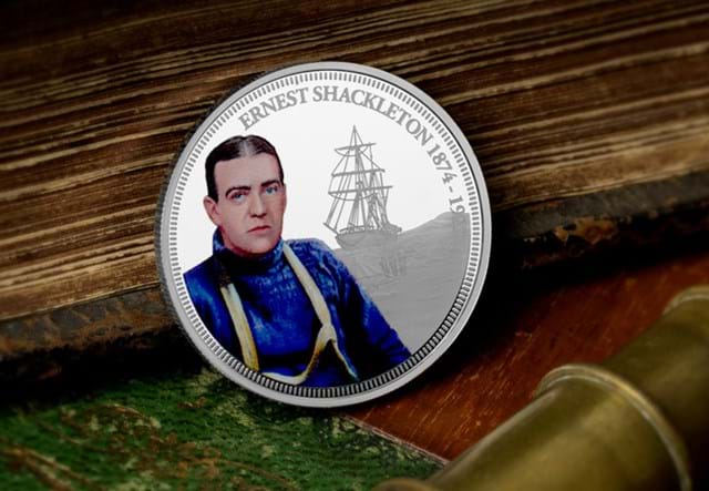 The Sir Ernest Shackleton Proof Coin reverse leaning against wooden surface