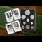 The Prince Philip Memorial Historic Coin and Stamp Collection laid on green and brown surface