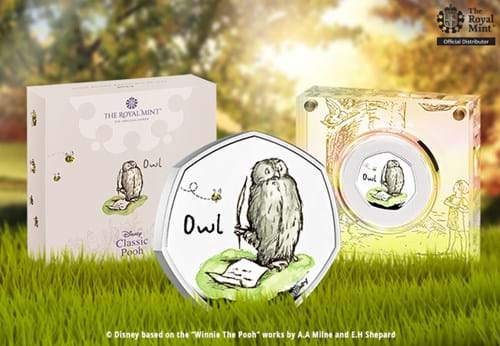 Silver Owl 50p beside packaging and perspex box with grassy background