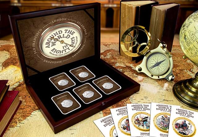 Around the World in 80 Days Silver 1st Strike 50p in display box on a desk beside a compass