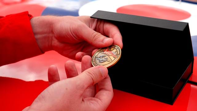 Challenge Coin In Hand Of Red Arrows