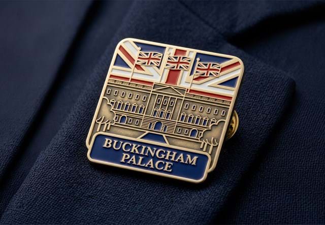 Buckingham Palace Badge On Blue Fabric 1300X900 1